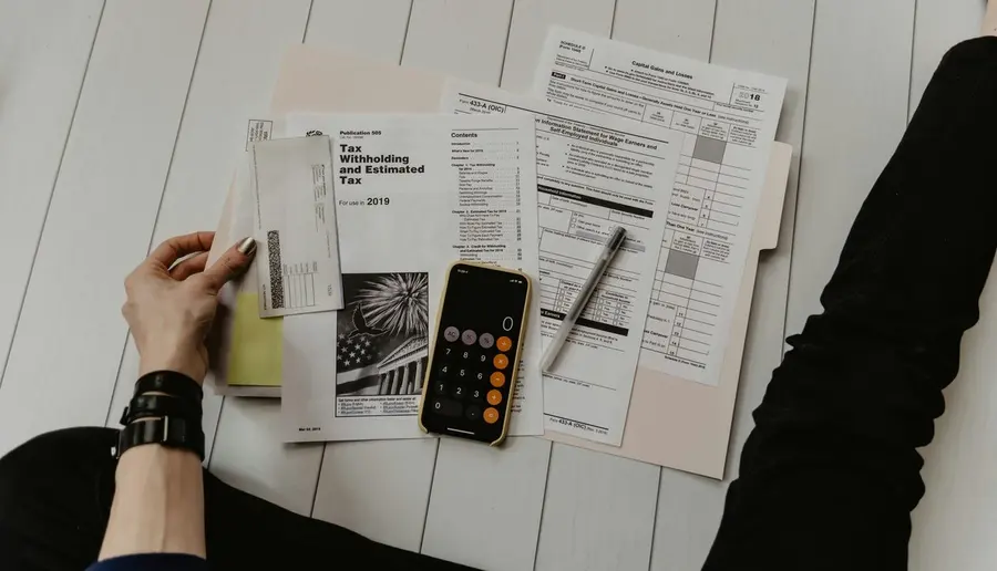 Financial paperwork and a calculator arranged on a table